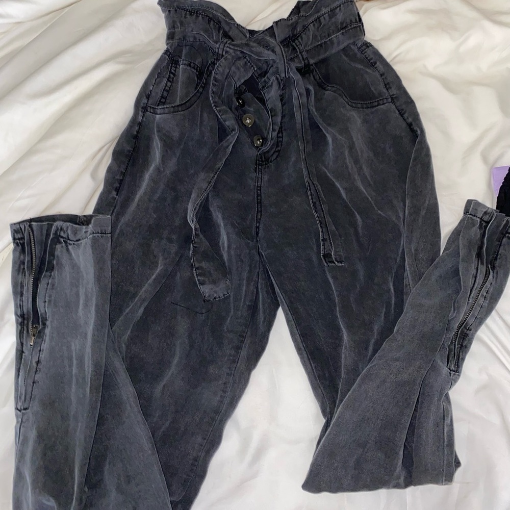 jean-like joggers with buttons and a belt, also zippers on the bottom